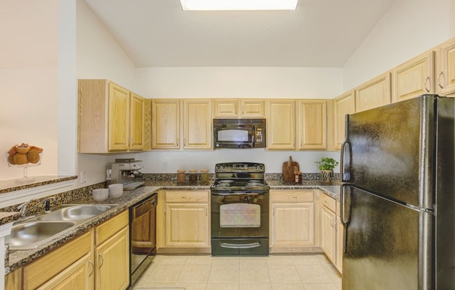 a kitchen with wood cabinets and black appliances