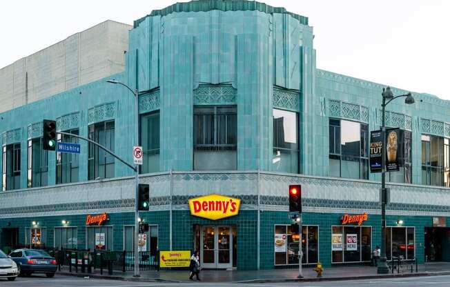 a large blue building with a domed top on the corner of a street