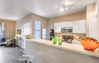 A kitchen with a white counter and a bowl on it.