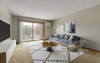 a spacious living room with a sliding glass door leading to a balcony