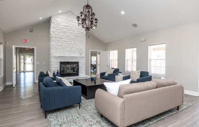 A living room with a fireplace and a chandelier.