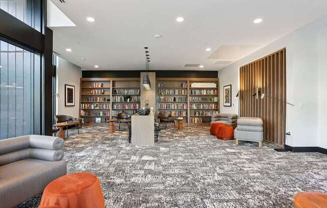 A library with a carpeted floor and bookshelves filled with books.