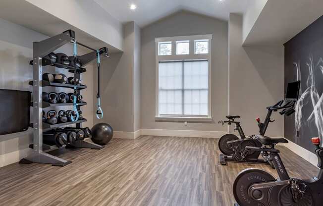 a home gym with exercise equipment and a bike at Reserve by the Lake, Houston, Texas
