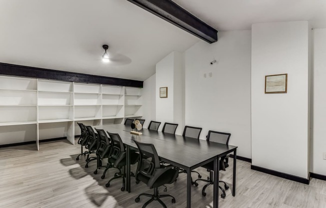 a conference room with a long table and chairs and a bookshelf