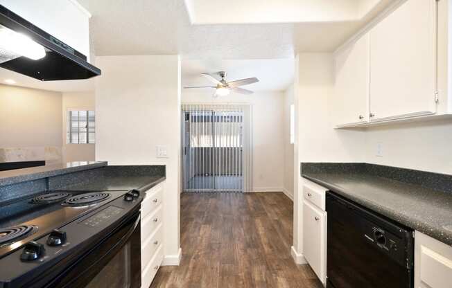 a kitchen with stainless steel appliances and white cabinets