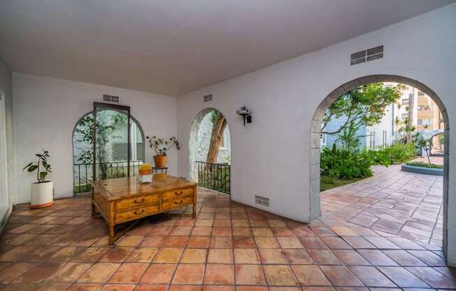 A room with a tiled floor and a wooden table.