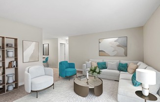 A living room with a white couch, blue chair, and a coffee table.