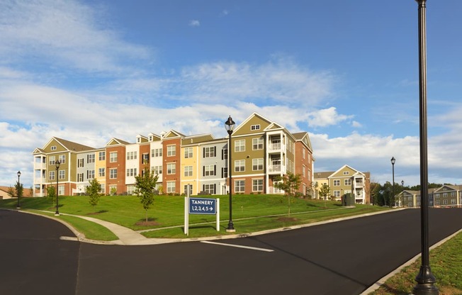 A street view of apartment buildings with a sign that says Tannen.