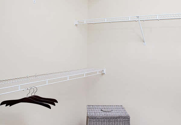 A room with a hanger and a box on the floor.