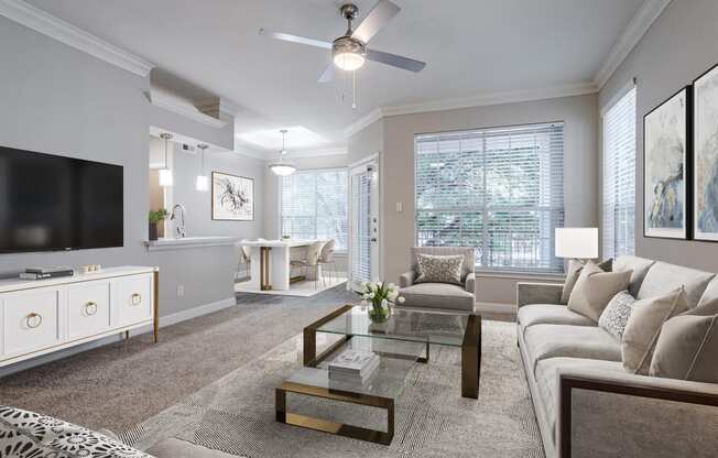 Houston Apartments – Gramercy Park – living room with large windows, ceiling fan, and a view of the dining room