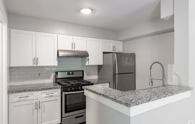 a kitchen with granite counter tops and stainless steel appliances