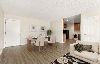 a living room and dining room with a table and chairs