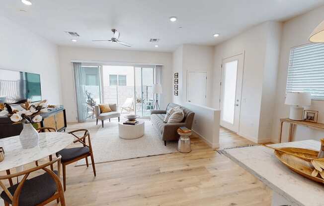 a living room with a couch and a table at Novella Biltmore, Phoenix, 85016