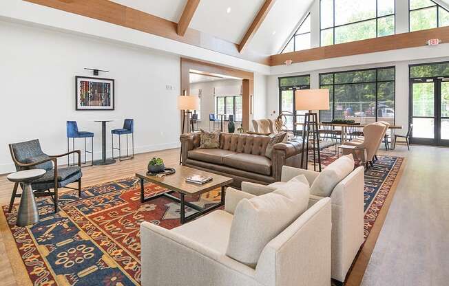 a large living room with couches and chairs and a large rug