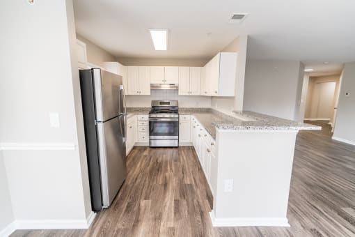 a renovated kitchen with white cabinets and stainless steel appliances at Merion Milford Apartment Homes, Milford, Connecticut