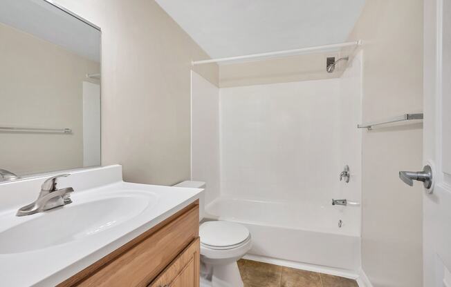 a bathroom with a sink and a toilet and a shower