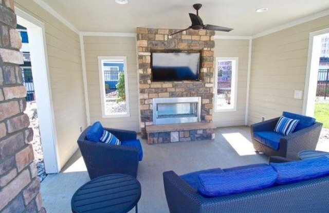 Pool cabana with flat screen television, fireplace, and 3 couches