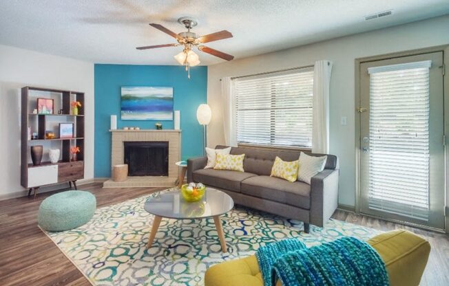 a living room with a couch and a ceiling fan