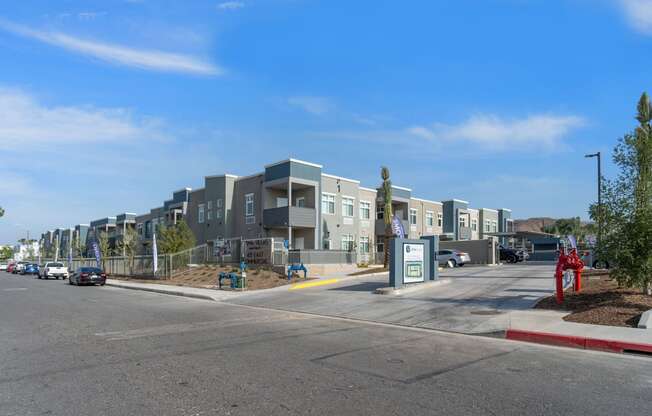 a row of apartment buildings with cars parked in front of them at Loma Villas Apartments, San Bernardino, 92408