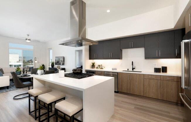 a modern kitchen with a large island with stools