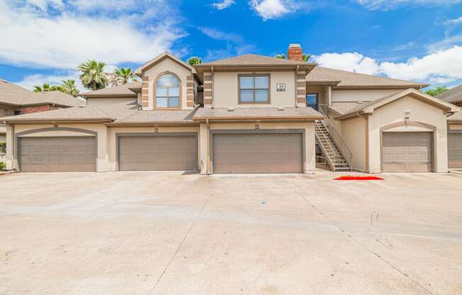 A large house with a driveway in front.
