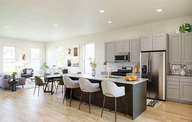open concept kitchen with gray cabinets and a large island at Anthem Apartments and Cottages in Huntsville, Alabama