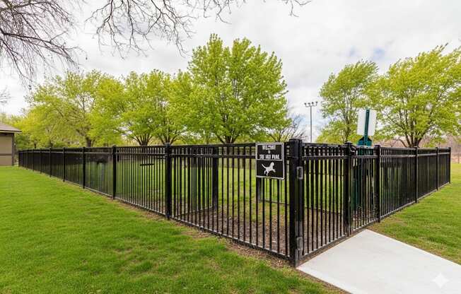 A black metal fence with a sign on it.