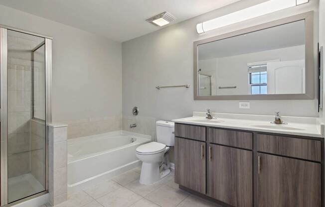 A bathroom with a toilet, sink, and shower.