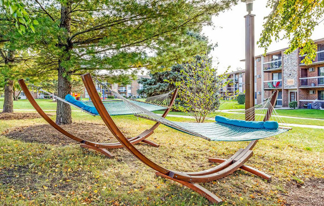 a couple of hammocks sitting next to a tree