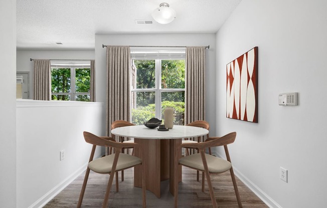A dining room with a table and chairs.