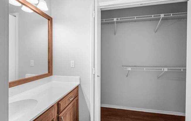 A bathroom with a white counter top and a white sink.
