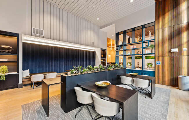 Modern dining and coworking area with a dark table and chairs at Preston Ridge in Cary, NC.