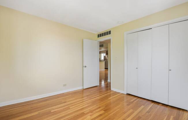 Large bedroom with hardwood flooring