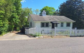 Cute white cottage with white picket fence & Huge deck off back door!