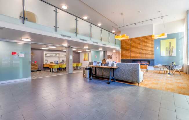 a large lobby with a table and a fireplace