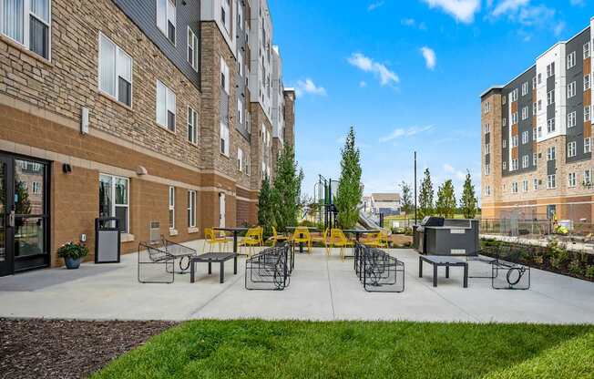 A sunny day at a courtyard with a playground and a building in the background.
