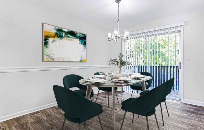 a dining room with a table and chairs at Elea Apartments in Marietta, GA