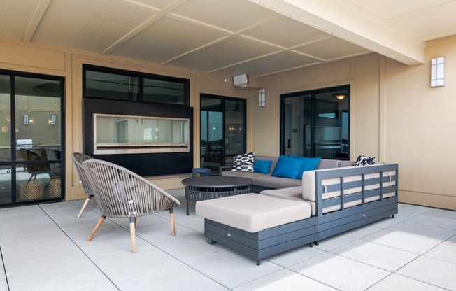 a seating area with a sofa chair and ottoman on a patio  at Century West Pryor, Missouri