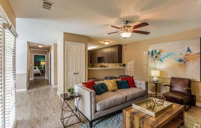 A living room with a couch, a chair, and a coffee table.