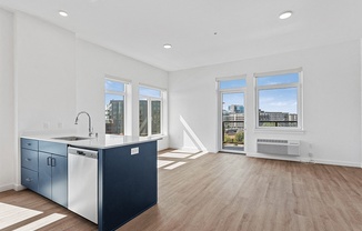an open kitchen and living room with a large window