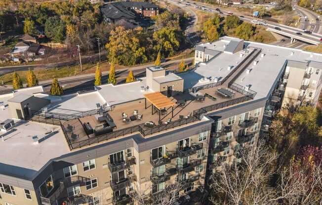 An aerial view of a multi-story apartment building surrounded by trees.