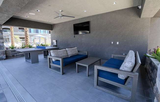 Poolside cabana with comfortable seating, ping pong table & TV