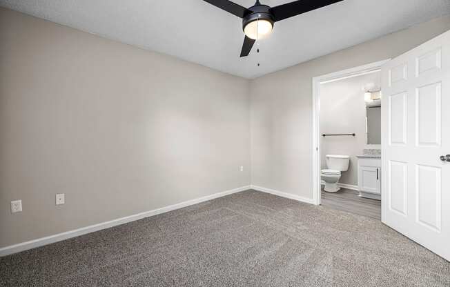 addison point interior home bedroom with a ceiling fan and a bathroom