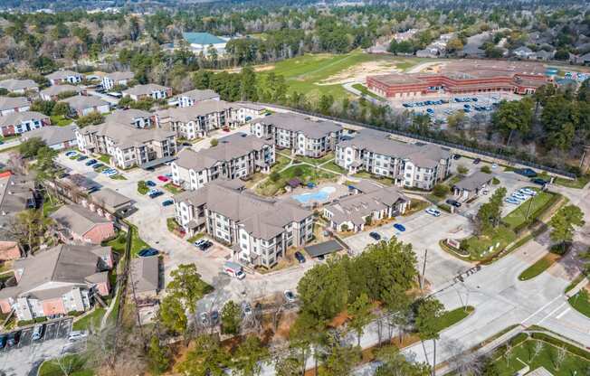 an aerial view of a group of apartment buildings and a parking lot