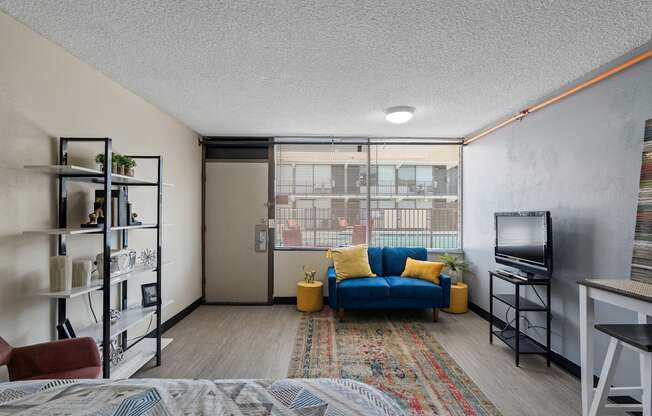 A living room with a blue couch and a television.