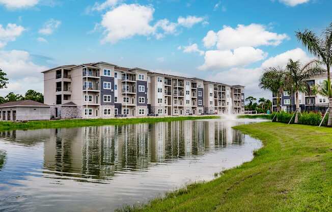 Vantage apartment building overlooking a pond with a fountain