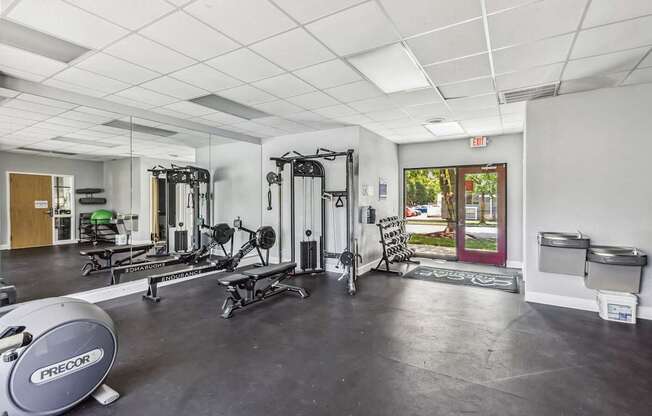 A gym with a variety of equipment including a Precor machine.