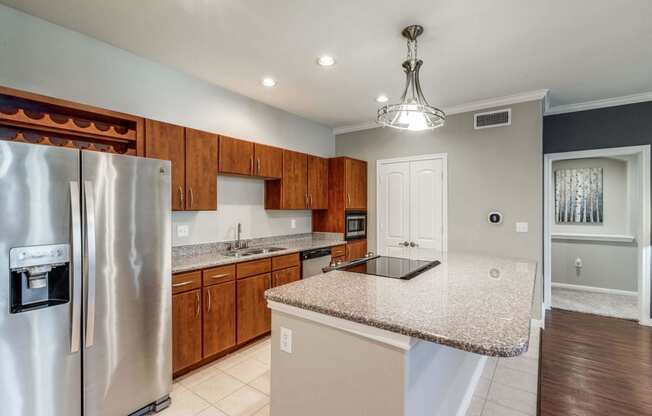 Kitchen with granite countertops and wooden cabinets at Vintage Park Apartments, Houston