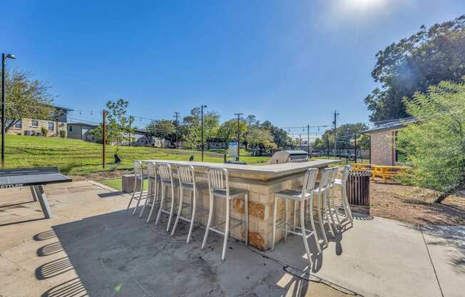 a patio with a table and chairs in a park  at Sunset Ridge, Texas, 78209