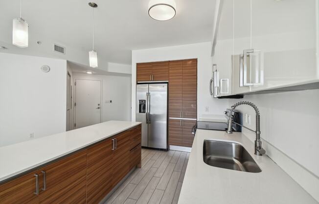 a kitchen with white countertops and wooden cabinets